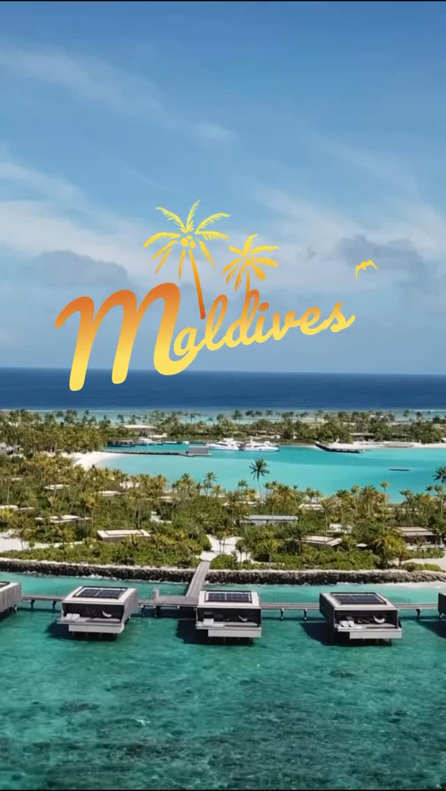A Maldives resort from the air, overwater villas along a turquoise lagoon